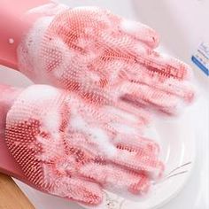 two pink gloves sitting on top of a white plate