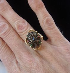 a close up of a person's hand with a ring on top of it