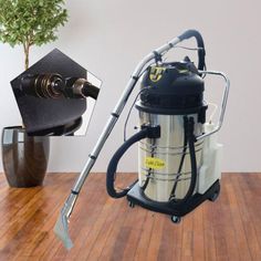 a vacuum is on the floor next to a potted plant