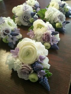 the bridal bouquets are laid out on the table ready to be put in