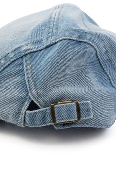 a denim cap with a gold buckle on it