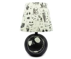 a black and white table lamp with a jack skellingy face design on it