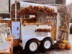 an ice cream truck is decorated with sunflowers and pumpkins for the fall season