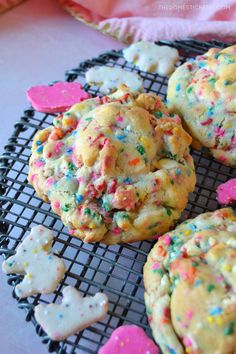 cookies with sprinkles and hearts on a cooling rack