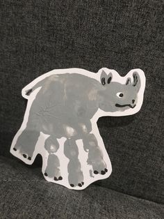 an animal shaped sticker sitting on top of a couch