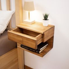 a nightstand with a lamp and books on it