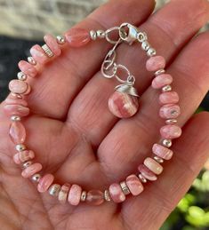 This gorgeous  bracelet features AAA natural Smooth rhodochrosite gems accented with sterling silver beads. The bracelet is finished with a 925 sterling silver clasp and extender chain.  Bracelet length is adjustable from approx. 6.5 to 7 3/4 inches Your order will arrive packed and ready for gifting.  Thanks for stopping by! Adjustable Pink Opal Bracelet, Pink Sterling Silver Bracelet With Lobster Clasp, Pink Beaded Sterling Silver Bracelets, Bracelet Sterling Silver, Petrified Wood, Gorgeous Bracelet, Sterling Silver Bracelet, Sterling Silver Bead, Silver Beads