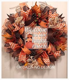 a wreath with the words welcome to our pumpkin patch on it and an orange chevron bow