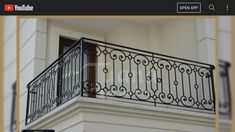 a balcony with wrought iron balconies and railings on the side of a building