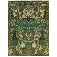 an antique rug with green and blue colors