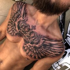 a man's chest with an angel tattoo on it