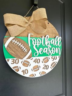 a football season door hanger with a bow on it