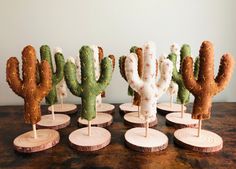 several small cactus sculptures on wooden bases