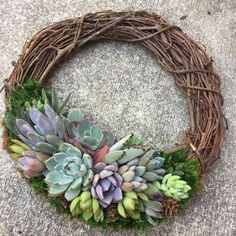 a wreath with succulents is sitting on the ground