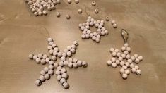 several snowflakes made out of beads on a table