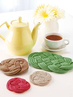 crocheted coasters and tea pot on a table