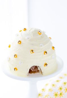 a cake with white frosting and yellow decorations