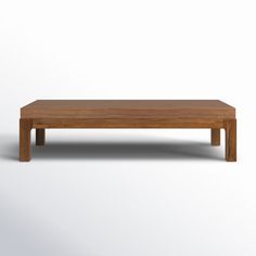 a wooden coffee table sitting on top of a white floor