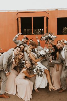 a group of people standing next to each other in front of a red train car