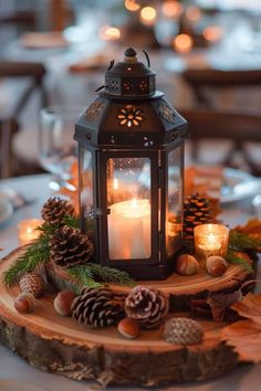 a lit candle is sitting on top of a tree stump with pine cones and other decorations