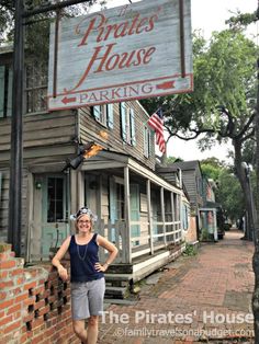 a woman standing in front of a building with a sign that says private house parking