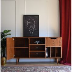 the sideboard is made from wood and has two compartments for books, magazines or other items