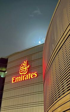 the emirates building is lit up at night