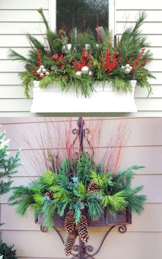 christmas decorations are displayed on the window sill with pine cones, evergreens and berries