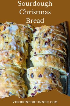 a loaf of bread with cranberries and white icing sitting on top of it