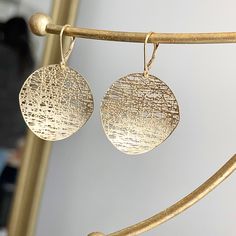 14KT yellow gold matte-finish, textured, round, cobweb/ filigree design circle disc lever back earrings. Nice, size discs that are concave. Measures: 45mm x 28mm Weighs 4.40 grams Stamped 14k Lever back closure Textured Gold Jewelry For Gifts, Gold Textured Jewelry For Gifts, Textured Gold Jewelry Gift, Matte Gold Round Earrings, Textured Drop Earrings For Gifts, Elegant Metal Round Disc Earrings, Elegant Gold Round Disc Earrings, Textured Round Jewelry For Gifts, Textured Round Jewelry Gift