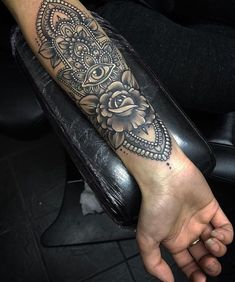 a woman's arm with a tattoo on it and a rose in the middle