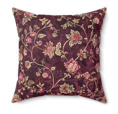 a purple pillow with pink flowers on it