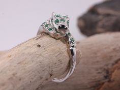 Thank you for looking at this beautiful item. Handmade from solid sterling silver. Made to the highest standard and perfection. Finish - High polish. Metal stamp - 925. Ring size - N (US Size 6 3/4). Emerald weight - 0.52ct with 1 surrounding Diamond at 0.005ct each. Gemstones - natural Emerald & natural Diamonds. Ring head width - 8.5mm Ring shank width - 1.8mm Total ring weight - 2.9 grams. Total Diamond weight - 0.005ct. Diamond colour - G - H. Diamond clarity - SI1 - SI2.   Comes supplied wi Luxury Green Sterling Silver Ring, Exquisite Silver Emerald Ring Hallmarked, Sterling Silver Multi-stone Green Emerald Ring, Head Ring, Natural Emerald, Emerald Diamond, Diamond Clarity, Metal Stamping, Rings Statement