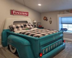 a bedroom with a bed and checkered comforter on the back of an old truck