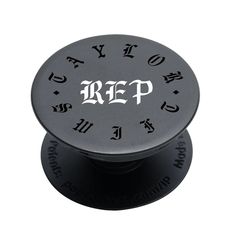 a metal knob with the word rep on it's center hole and letters in black ink