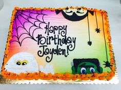 a birthday cake that is decorated with halloween decorations