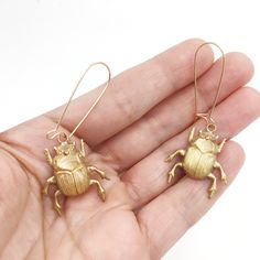 These brass scarab earrings are handcrafted in the USA (Jersey City, New Jersey!) These brass beetle earrings make the perfect gift for the bug lover in your life. Insect jewelry also makes a great gift for science teachers, gardeners, entomologists or entomology students -- any insect lover that can appreciate the tiny magic of our six-legged cousins! 💕🐜🐞🐝🦗🐛🦋💕 The ear wires on these scarab beetle earrings have an easy-to-secure catch at the back so they don't slip out! The ear wires are Scarab Earrings, Beetle Scarab, Insect Earrings, Beetle Jewelry, Scarab Jewelry, Beetle Earrings, Bug Earrings, Dung Beetle, Beetle Insect