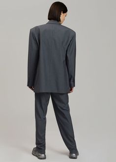 Color: Dark Grey Melange Midweight traditional suiting fabric Oversized tailored silhouette Padded shoulders Button front closure Flap front pockets Lined 65% Lyocell 25% Rayon 10% Wool Dry Clean By The Frankie Shop. Imported Classic Button-up Suit For Workwear, Business Pantsuit With Notch Lapel And Pockets, Business Pantsuit With Suit Collar And Pockets, Tailored Business Pantsuit With Pockets, Structured Office Suits With Welt Pockets, Structured Double Button Business Suits, Structured Business Suits With Pockets, Classic Office Wear Pantsuit With Pockets, Classic Pantsuit With Pockets For Work