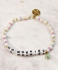 a white beaded bracelet that says no worryies won't lie on it