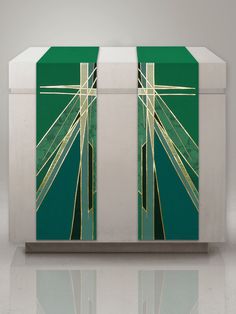 a green and white box with gold lines on the front, sitting on a reflective surface