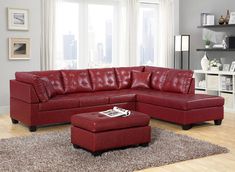 a living room with a red couch and ottoman