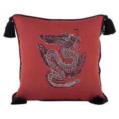 a red and black pillow with a dragon on it