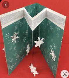 an open christmas card with snowflakes on it