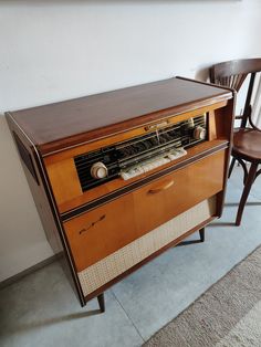 an old radio sitting on top of a wooden cabinet