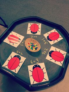 a child's play table with ladybugs and numbers on the side,