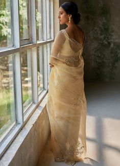 Embrace timeless elegance with the stunning Beige Gold Embroidered Pure Silk Organza Saree, crafted from luxurious pure silk organza fabric. This golden saree features intricate aari hand embroidery, with delicate floral and paisley patterns meticulously crafted to highlight its rich texture and add a touch of sophistication. Paired with a matching silk blouse, this ensemble exudes grace and style. An Ideal for making a statement at Mehendi and Sangeet ceremonies or as a standout wedding guest outfit where you wish to stand out. Composition : Saree - Pure Silk Organza, Blouse- Pure Habutai Silk Care: Dry Clean Only and Vacuum Storage This product can be customized for sleeves, length and colour Delivery : 4-6 weeks as the product is hand crafted. Check Size Guide or choose MySize for free Silk Organza Fabric, Golden Saree, Organza Blouse, Vacuum Storage, Indian Wedding Wear, Organza Saree, Organza Fabric, Indian Fashion Dresses, Silk Organza