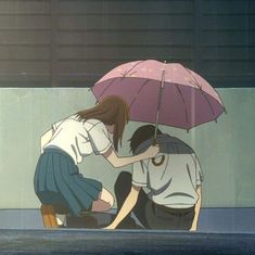 two people sitting on the ground with an umbrella over their heads and one person kneeling down