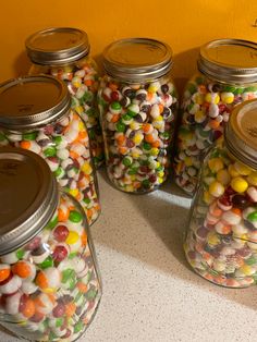 several jars filled with different types of candy