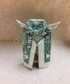 an origami elephant made out of one dollar bill and another hundred dollar bill