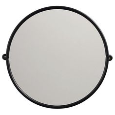 the round mirror is black and white with metal trimmings on it's sides